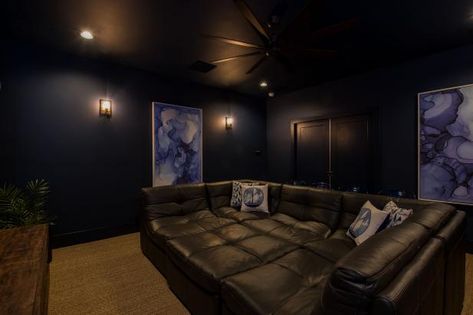 Check out this home theater with dark walls and a leather sectional on HGTV.com. Dark Home Cinema Room, Navy Theater Room, Navy Blue Theater Room, Dark Moody Theatre Room, Navy Blue Movie Room, Dark Blue Movie Room, Dark Home Theatre Room, Dark Blue Theater Room, Blue Theatre Room