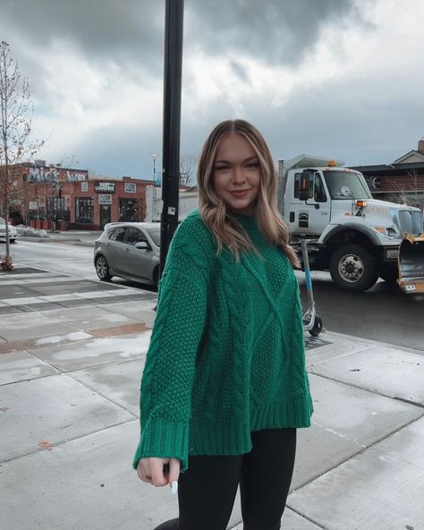 Girl walking on street wearing a green chunky cable knit sweater with a cloudy sky and businesses in the background Green Chunky Knit Sweater For Winter, Green Chunky Sweater, Oversized Green Sweater For Streetwear, Oversized Green Chunky Knit Sweater, Oversized Green Chunky Knit Top, Winter Aesthetic, Chunky Sweater, Green Sweater, Cable Knit