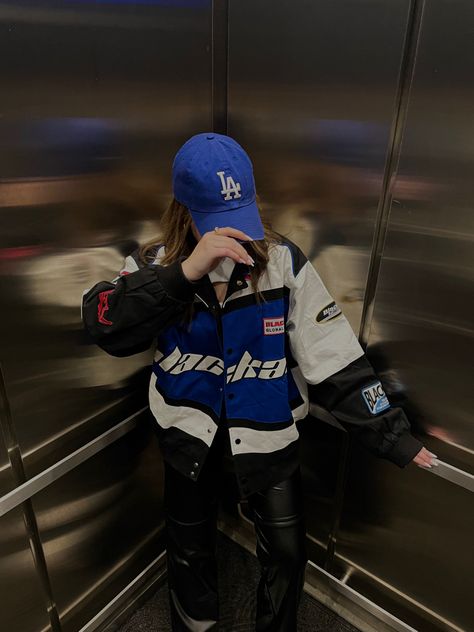 Base Ball Cap Outfit Black Women, Blue Racer Jacket Outfit, Racer Style Outfit, F1 Aesthetic Outfit, Blue La Hat Outfits, Blue Baseball Cap Outfit, La Dodgers Hat Outfit, Racer Girl Outfit, Dodgers Hat Outfit