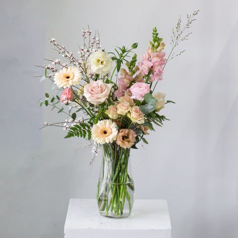 A variety of blooms and textures styled in a tall glass vase. The vase is 9" tall. The whole arrangement is approximately 18" tall and 8" in diameter. Please note: Photos are examples of size and style only. We work with a different variety of flowers each week. Your bouquet will be unique to you. We cannot replicate photos or past orders. While we encourage design notes and requests, we cannot guarantee specific flowers and/or colours. Tall Pink Flower Arrangements, Tall Narrow Vase Arrangement, Floral Arrangement In Vase, Flower Vase Bouquet, Flowers In Tall Vase, Pink Vase With Flowers, Tall Floral Arrangements For Home, Long Vase Flower Arrangements, Flower Colour Palette