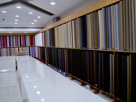 Saree Showroom Elevation Design, Textile Store Interiors, Textile Shop Design, Design Center Showroom Display, Cash Counter Design For Cloth Shop, Fabric Store Design Interior, Shop Counter Design Clothes, Cloth Showroom Interior, Garments Shop Counter Design