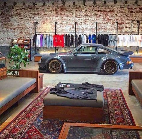 25 Coolest Automotive Living Space To Your Interior Styles | Home Design And Interior Loft Garage Industrial, Garage With Couch, Garage Couch Ideas, Garage Industrial Design, Car Shop Office Ideas, Garage Wall Mural Ideas, Industrial Garage Ideas, Mens Garage Ideas, Porsche Room Decor