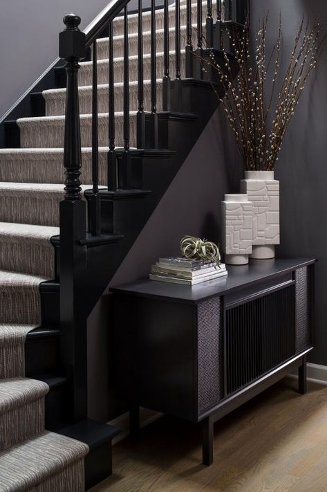 HGTV presents this contemporary foyer featuring a charcoal gray wall color, neutral stair runner, black painted railing and modern credenza with white ceramic accessories. Black Painted Stairs, Black Foyer, Stairs And Hallway Ideas, Stairs Runner, Black Staircase, Painted Staircases, Black Stairs, House Staircase, Staircase Remodel