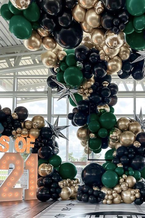 Create a show-stopping display for your graduation party with this luxurious balloon arch in black, gold, and emerald green. Enhanced with shiny silver star accents, this stylish decor is perfect for making a bold statement at any celebration. Whether as a backdrop for photos or a dramatic entrance piece, this balloon arrangement is ideal for elevating your Class of 2021 party or any milestone event with a modern and glamorous touch! Green Gold Balloon Garland, Gold Balloon Arch, Balloon Arrangement, Green Balloons, 40th Birthday Party Decorations, Black And Gold Balloons, Dramatic Entrance, Balloon Arrangements, Garland Arch