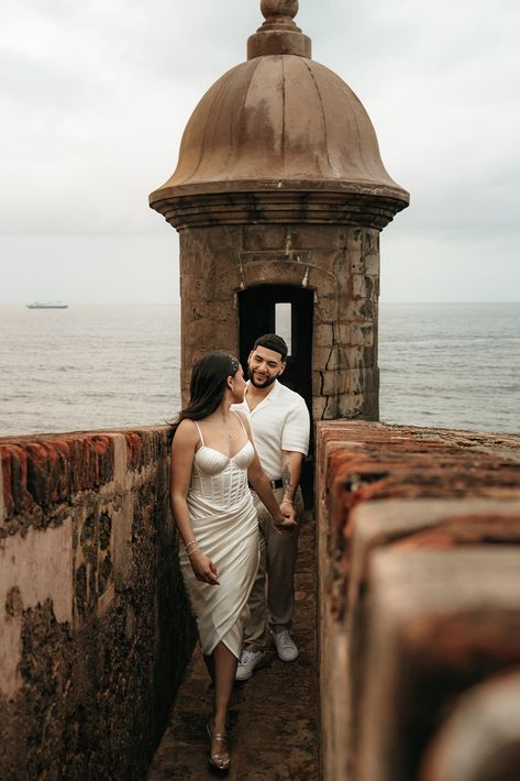 woman in white dress holding hand and leading him forward out of a Spanish fort. Engagement Photos Mission San Juan, Engagement Photos San Juan Capistrano, San Juan Photoshoot, San Juan Puerto Rico Engagement Photos, San Juan Engagement Photos, Latino Engagement Photos, St Augustine Florida Engagement Photos, Old San Juan Photoshoot, Engagement Photos Puerto Rico