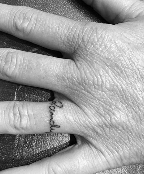 Top 57 Name Tattoo Ideas [2020 Inspiration Guide] Husband Name Tattoos For Women Finger, Name Tattoo In Finger, Ring Name Tattoo, Name Tattoos On Finger, Husband Name Tattoo On Ring Finger, Name On Ring Finger Tattoo, Ring Finger Tattoo Couple Name, Rachel Tattoo The Name, Boyfriends Name Tattoo Ideas