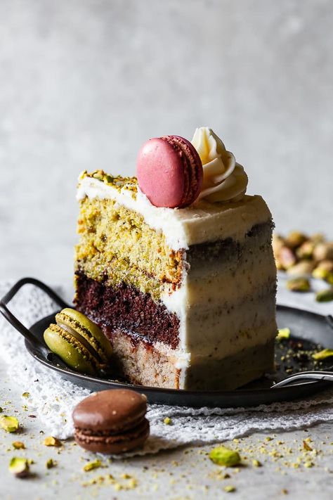 This exquisite Italian Spumoni Cake showcases a delicious trio of strawberry, chocolate and pistachio layered cake. It is crowned with elegantly swirled buttercream and topped with macaron cookies, creating a visibly stunning dessert. Bake Off Cakes Ideas, Tiramisu Layer Cake Recipe, Fancy Italian Desserts, Italian Plated Desserts, Crazy Cake Flavors, Italian Fruit Cake, Impressive Holiday Desserts, Pistachio Almond Cake, Gourmet Birthday Cake