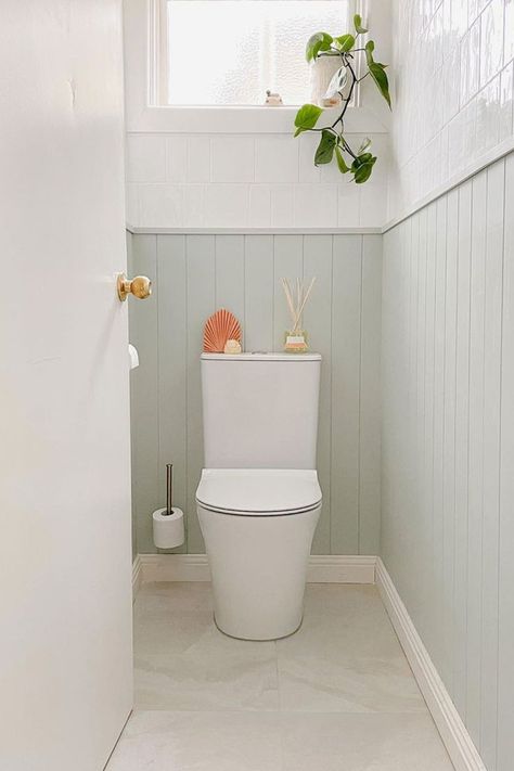 Small toilet room featuring VJ panelling painted in Tint's Inner Self Wall Paint, featuring minty undertones. Tiles Toilet Room, Coastal Toilet Room, Vj Panelling Bathroom Half Wall, Panelled Downstairs Toilet, Pastel Toilet, Toilet Transformation, Coastal Toilet, Vj Panelling Bathroom, Tiled Toilet