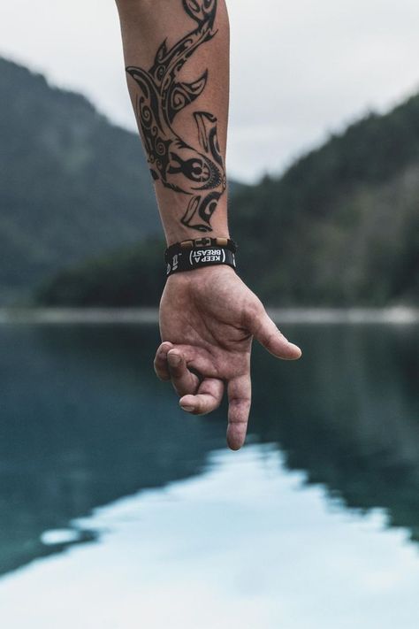 Picture of detailed vegan tattoo on forearm with beautiful lakes and mountains in the background. Shark Tattoo Meaning, Unique Wrist Tattoos, Vegan Tattoo, Wrist Tattoos For Guys, Shark Tattoos, Tattoo Aftercare, Cool Small Tattoos, Hand Tattoos For Guys, Small Tattoo Designs