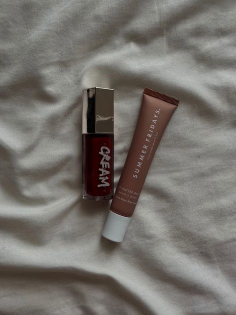 A fenty beauty cream lip gloss and summer Fridays lip balm sit by each other on a white blanket Fenty Beauty Lip Gloss Aesthetic, Fenty Lipgloss, Fenty Beauty Lip Gloss, Fenty Gloss, Summer Fridays Lip Butter Balm, Summer Fridays Lip, Lip Butter Balm, Red Lip Gloss, Fall Makeup Looks