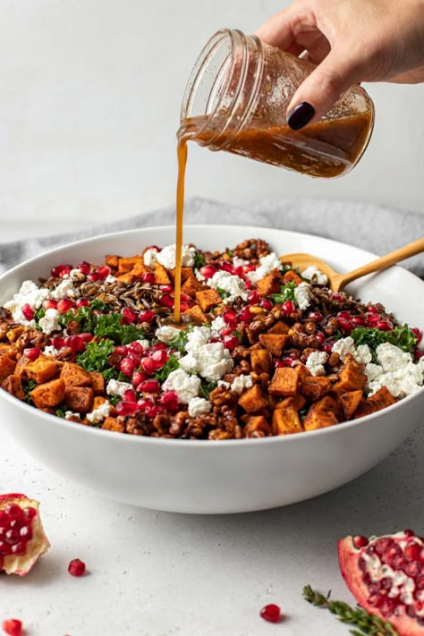 Every holiday table needs a fresh, over-the-top salad! This Thanksgiving Salad balances the rich flavors at Thanksgiving with festive flair. Made with massaged kale, wild rice, spiced sweet potatoes, maple candied nuts, pomegranate arils, goat cheese, & a simple cider-cinnamon vinaigrette, this harvest salad is colorful, elegant, super fresh, & so hearty – it just might steal the show at your Thanksgiving table this year! Naturally vegetarian & gluten-free, easily dairy-free & vegan. Thanksgiving Side Salads, Cinnamon Vinaigrette, Spiced Sweet Potatoes, Thanksgiving Salad Recipes, Cider Vinaigrette, Thanksgiving Salad, Holiday Salads, Cooking Wild Rice, Massaged Kale