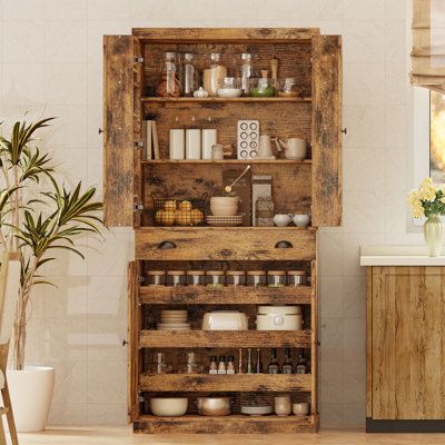 This pantry cabinet offers a versatile storage solution for your kitchen or any room in your home. Crafted from engineered wood, it features paneled drawers and black knob and cup pull handles for a classic look. With four doors, one drawer, and four shelves, this cabinet provides ample space to store food, small appliances, and kitchen supplies. The six door shelves are just right for organizing spice jars and canned goods, while the three sliding shelves offer flexible storage options. Plus, t Seasoning Storage Ideas, Homesteading Pantry, Herb Storage Ideas, Rustic Pantry Ideas, Home Apothecary Room, Hanging Kitchen Storage, Shelving Pantry, Antique Pantry, Food Pantry Cabinet