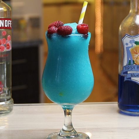 The Frozen Blue Raspberry is a little slushy, boozy dream. This stunning blue cocktail combines raspberry vodka, blue curacao, orange juice, lime juice, sour mix, and raspberries, and is guaranteed to satisfy all those raspberry mixed drink lovers out there. Blue Raspberry Drinks Alcohol, Blue Raspberry Mixed Drinks, Blue Beverages, Boozy Slushies, Raspberry Vodka Drinks, Frozen Drinks Alcohol, Raspberry Margarita, Vodka Blue, Raspberry Drink