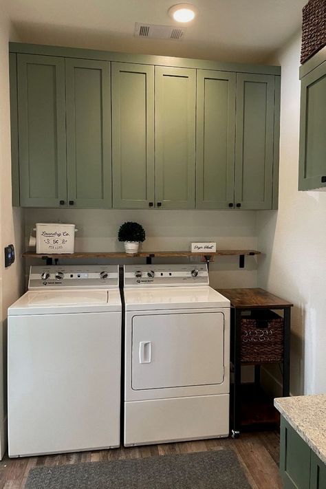 Washer And Dryer With Cabinets Above, Bathroom/laundry Room Paint Colors, Laundry Room Cabinets Above Washer Dryer, Laundry Room Above Cabinet Storage, Storage Above Washer Dryer, Farmhouse Laundry Room Green Cabinets, Wall Cabinets For Laundry Room, Above Washer Cabinets, Green And Gray Laundry Room