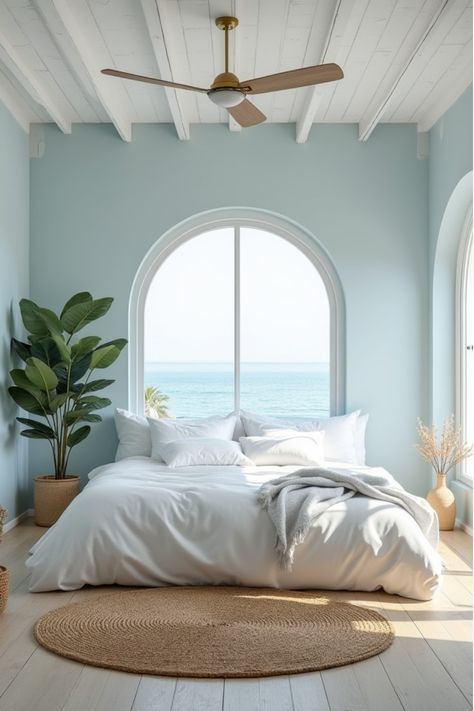 Bright coastal-themed bedroom with blue walls and natural textures Pale Turquoise Bedroom, Ocean Colors Bedroom, Light Blue Wall Paint Bedroom, Beach Bedroom Paint Colors, Light Blue And Beige Bedroom, Baby Blue Room Ideas, Calming Blue Bedroom Walls, Blue Bedroom Paint Colors, Pastel Blue Room