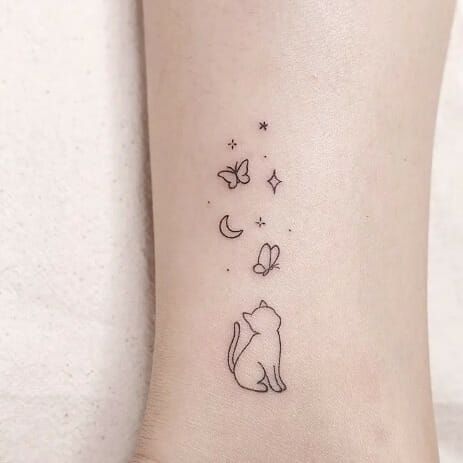 A minimalist cat tattoo can be a charming and subtle way to express your love for felines. Consider a simple outline of a cat's silhouette, perhaps with clean lines and minimal detail. You could opt for a small design on your wrist, ankle, or behind the ear for a discreet yet stylish look. Black ink tends to work well for minimalist tattoos, but you could also explore other subtle colors if you prefer. Just ensure you find a talented tattoo artist who specializes in minimalist designs Tiny Cat Tattoos For Women, Cat With Butterfly Tattoo, Simple First Tattoos For Women, Cute Cat Tattoo Simple, Cat Butterfly Tattoo, Butterfly Simple Tattoo, Cat And Butterfly Tattoo, Tattoo For Cat, Butterfly Minimalist Tattoo