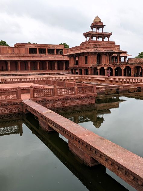 Fatehpur Sikri stands as a testament to the architectural brilliance of the Mughal era. Commissioned by Emperor Akbar in 1571, this once-thriving city was envisioned as a grand capital but was eventually abandoned due to water scarcity. Today, it remains frozen in time, its red sandstone structures echoing tales of emperors, saints, and cultural fusion. Fatehpur Sikri Architecture, Fatehpur Sikri Photography Poses, Fatehpur Sikri Photography, Photography Buildings, Fatehpur Sikri, Architecture Photography Buildings, Red Sandstone, Mughal Architecture, Water Scarcity