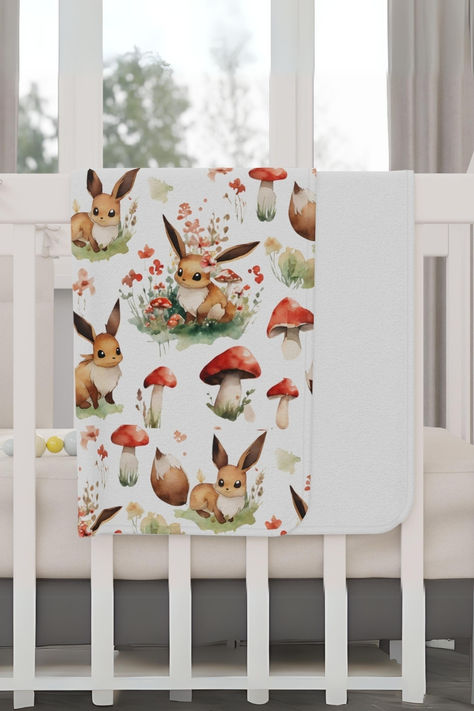 Checkout this adorable toddler blanket that features our very own unique mushroom, floral, and eevee woodland design. This would make the perfect addition to any baby nursery, available on YebbaDesignsCo on Etsy. #cottagecore #eevee #babyblanket #pokemongift #babyshowergift #showergift #nerdy #pokemonbaby #babygifts #toddlergifts #gamergirl #toddlerblanket Dnd Baby Nursery, Pokemon Nursery Theme, Pokémon Nursery, Mushroom Baby Blanket, Pokemon Nursery, Nerdy Nursery, Aesthetic Watercolor, Baby Pokemon, Nursery Decor Inspiration