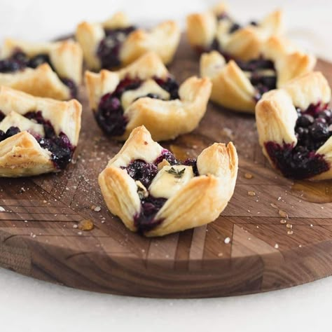 These easy blueberry brie puff pastry bites are the perfect little appetizers you can throw together for any holiday gathering. With only 5 ingredients and filled with gooey brie and jammy wild blueberries, they're sure to please all of your guests! Blackberry Brie Bites, Blueberry Brie Puff Pastry, Blueberry Brie Bites, Blueberry Pastry Recipes, Puff Pastry Brie Bites, Blueberry Appetizer, Blueberry Baked Brie, Brie Bites Puff Pastry, Blueberry Puff Pastry