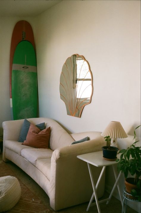 Vintage furniture, mirror, and accents helped to bring this Florida beach shack to life. Mcm Beach Decor, Beach Couch, Beach Aesthetic Interior Design, Small Beach Cottages Interior, Vintage Surf Shack Decor, 70s Beach House, Vintage Surf Bathroom, Vintage Beach House Decor, Surf Shack Bedroom