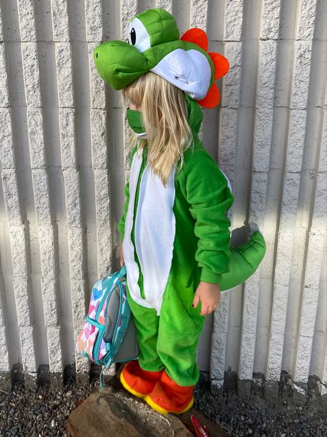 I’m really proud of the Yoshi costume this year. Green footie pjs, that I took the feet off and added Yoshi’s signature Orange shoes to (They slip right over whatever shoes she is wearing). Store bought head and shell. But I sewed on the shell. Also made the green and white tail and added the white to her front. And finally, I made Yoshi’s, Bowsers, Mario and Luigi’s masks Diy Yoshi Costume Kids, Yoshi Halloween Costume, Yoshi Halloween, Yoshi Costume, Cute Pink Hair, Mario Bros Costume, Mario Birthday Cake, Mario Y Luigi, Mario Costume