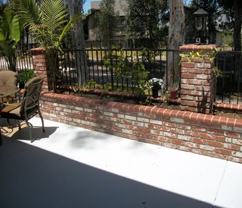 Brick and wrought iron fence. Wrought Iron Fence On Brick Wall, Crumbling Wall, Brick Fences, Lawn Free Yard, Stairs Entryway, Brick Wall Gardens, Iron Stairs, Iron Fencing, Iron Fences