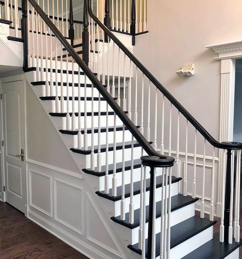 "Decided to do away with the dated carpeted wood stairs and go with a modern jet black and and white look. For the black, we used General Finishes Gel Stain with the General Finishes High Performance flat as the top coat, which gave the treads a painted look while allowing the natural wood grain to show. The white was Sherwin-Williams Pro Classic Semi Gloss. As first timers using General Finishes Gel Stain, the products were great to work with and the results speak for themselves!" - Burge Paint Painted Wood Stairs, Dark Staircase, Stairs Makeover Design, Black And White Stairs, Railing Makeover, Diy Stairs Makeover, Stair Railing Makeover, Stairs Makeover Ideas, Black Railing