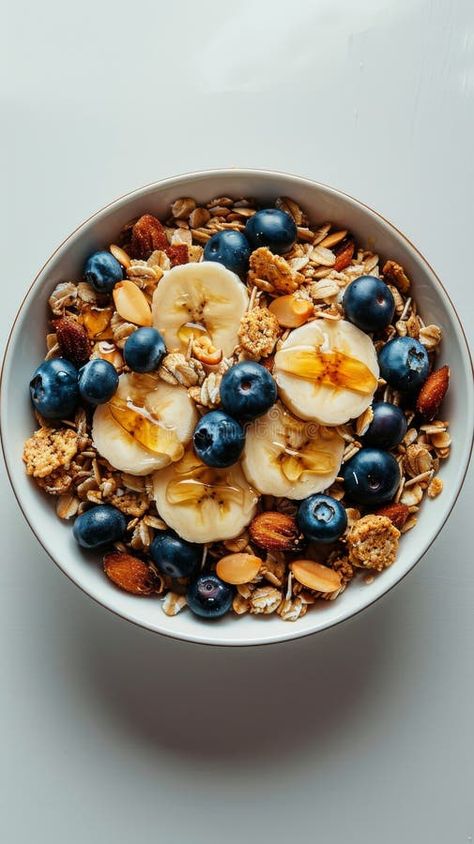 A bowl filled with granola topped with blueberries and slices of banana. The concept of a healthy breakfast. stock photos A Healthy Breakfast, A Bowl, Blueberries, Granola, Oats, Healthy Breakfast, Oatmeal, Vector Free, Nutrition