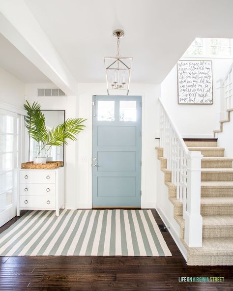 Beach House Front Door Coastal, Coastal Foyer Lighting Entryway, Modern Coastal Foyer Lighting, Modern Coastal Foyer Entryway, Light Blue Doors Interior, Light Blue Front Door White House, Coastal Blue Front Door, Modern Coastal Front Door, Light Blue Interior Doors