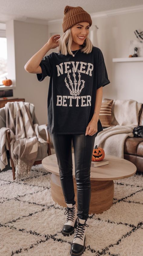 Stay stylish this fall with this fun and edgy outfit! The "Never Better" skeleton graphic tee adds a playful touch, while the sleek leather leggings keep it chic. Perfect for pumpkin spice outings or cozy nights in, complete the look with your favorite boots for an effortlessly cool vibe! Graphic Tee Leggings Outfit, Black Tshirt Outfit, Tee Shirt Outfit, Halloween Tee Shirts, Favorite Boots, Tshirt Outfits, Halloween Tees, Leather Leggings, Edgy Outfits