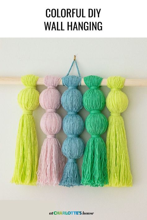 How to make a colorful wall hanging out of inexpensive yarn. #wallhanging #fiberart #budgetart Yarn Wall Hanging Diy, Diy Hanging Decor, Diy Yarn Wall Hanging, Yarn Art Diy, Pom Pom Wall Hanging, Yarn Decor, Diy Wall Hanging Yarn, Wool Crafts Diy, Tassel Wall Hanging