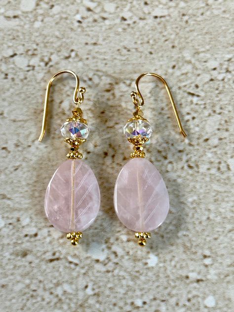 Rose Quartz earrings featuring a 25MM carved rose quartz teardrop stone accented with an 8MM aurora Borealis crystal rondelle bead and gold plated bead caps.  Earwires are gold filled.  Earrings measure 1 1/2 inches.  Handmade Rose Gold Beaded Earrings, Crystal Bead Jewelry Ideas, Beaded Crystal Earrings, Stone Earrings Diy, Gemstone Bead Earrings, Rondelle Beads Ideas, Earrings Design, Earrings Ideas, Bead Earrings Ideas