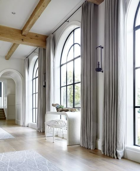 Floor to ceiling drapes around these arched black window frames. Hardenburg Designs Arched Window Coverings, Curtains For Arched Windows, Arched Window Treatments, Black Window Trims, Arch Windows, Black Window Frames, Modern Window Treatments, Arch Window, Modern Farmhouse Home