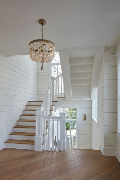 Coastal Stairwell, Entryway Coastal, Coastal Farmhouse Foyer, Coastal Millwork, Beach House High Ceilings, Lake House Inspiration, Nantucket Home Interior, Stairs Beach House, Coastal Staircase Ideas