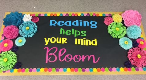 Bright and colorful Reading Helps Your Mind Bloom bulletin board I made for my classroom! I can’t wait for my third graders to see it!! Reading Helps Your Mind Bloom, Reading Makes Your Mind Bloom, Plant Seeds Of Kindness Bulletin Board, Reading Door Decorations, Bloom Bulletin Board, Spring Library Bulletin Boards, Flowers Bulletin Board, Garden Theme Classroom, 2024 Classroom