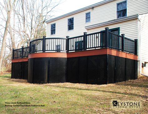 Custom Azek Redland Rose decking with TimberTech Black RadianceRail. This Deck also features Black Lattice around the bottom of the deck. Built by Keystone Custom Decks. Cedar Deck With Black Railing, Brown Deck With Black Railings, Black Lattice Under Deck, Dark Brown Deck Black Railing, Trex Deck With Black Railing, Deck Skirting Ideas, Lattice Deck, Skirting Ideas, Black Pergola