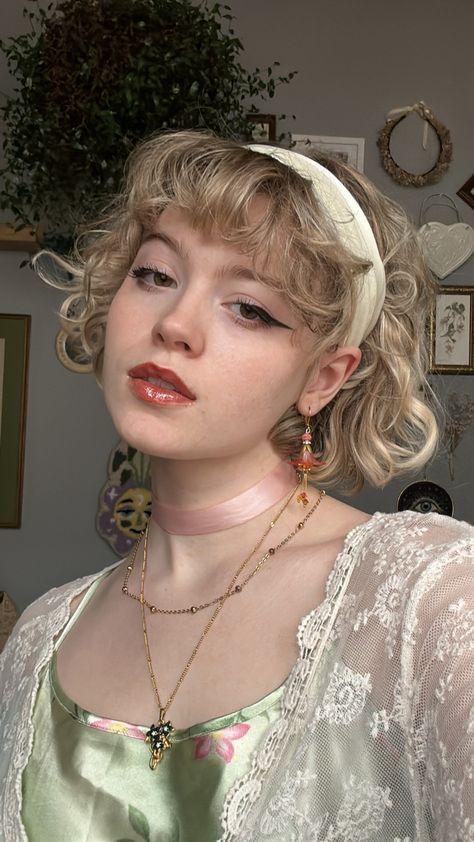 Girl wearing flower jewelry, a green slip dress, and lacy cardigan looking sideways with mouth partially open Cottagecore Hair Color Ideas, Cottagecore Hairstyles Short, Cottagecore People, Cottage Core Hairstyles, Pink Hair Styles, Cottage Core Hair, Cottagecore Hairstyles, Curly Pink Hair, Cottagecore Hair