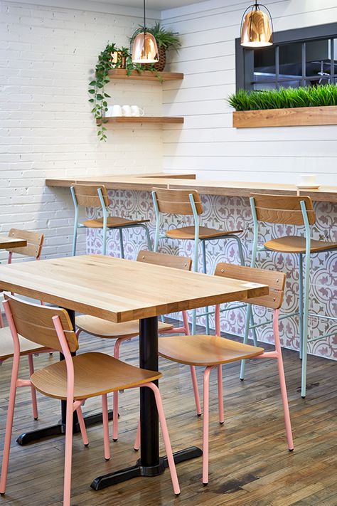 Pink and light blue restaurant chairs fill this colorful brunch bar in Grand Rapids. Cafe Table Chair Design, Restaurant Table Chair Design, Cafeteria Tables And Chairs, Restaurant Table And Chair Design, Restorent Table Design, Restaurant Tables And Chairs Ideas, Tables And Chairs For Cafe, Restaurant Table Ideas, Cafe Chair Design