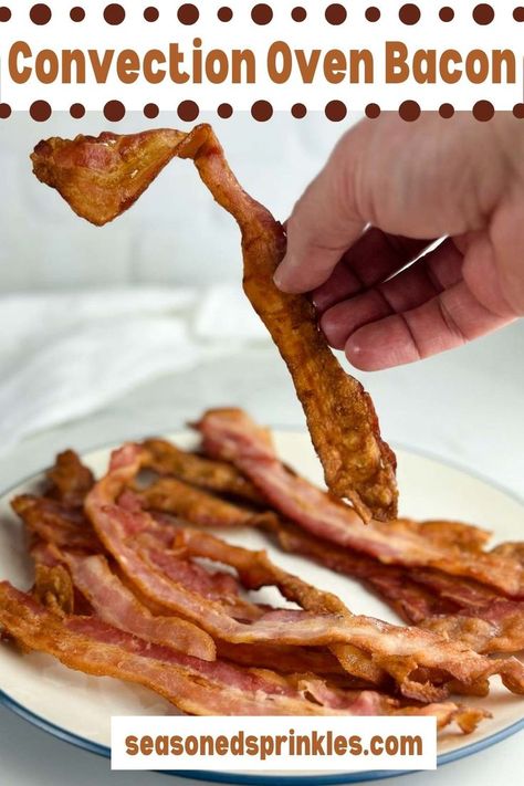 a hand picking up bacon Bacon In Convection Oven, Vegetarian Breakfast Casserole, Convection Oven Recipes, Air Fryer Recipes Low Carb, Bacon In The Oven, How To Make Bacon, Breakfast Casseroles, Cooking Bacon, Baked Bacon