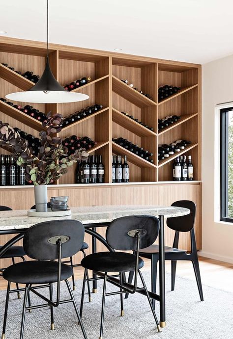 After two decades in an unrenovated 1960s house, a busy executive made more space for herself, her daughter — and a prized wine collection. Wine Storage Wall, 1960s House, Built In Dresser, Bungalow Renovation, Compact House, Grey Countertops, Wine House, Red Brick House, Wine Wall