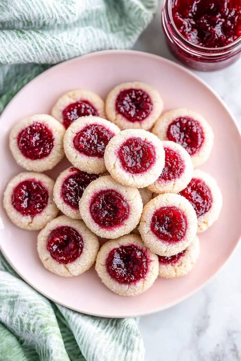 These buttery, soft raspberry thumbprint cookies with sticky jam center bring a little fruity magic to every bite. They're almost too good to share! Rasberry Thumbprint Cookies, Raspberry Thumbprint, Fruity Cookies, Raspberry Thumbprint Cookies, Jam Thumbprint Cookies, Thumbprint Cookies Recipe, Raspberry Cookies, Jam Cookies, Cranberry Cookies