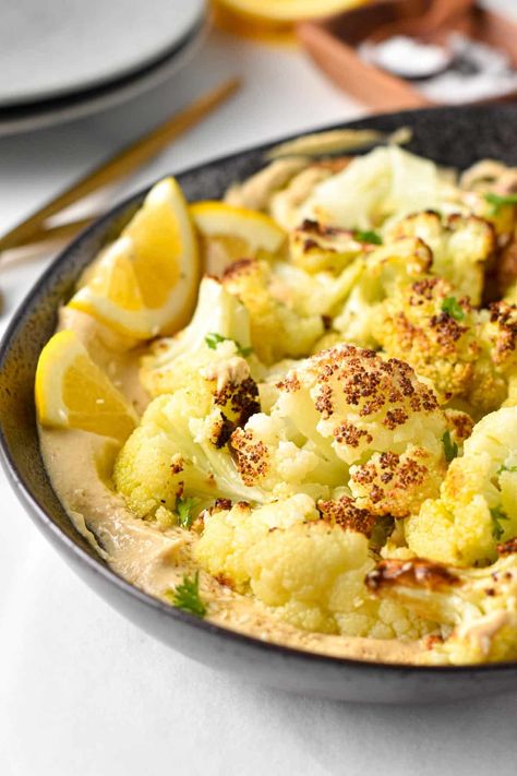 This Roasted Cauliflower with Tahini is the easiest sheet pan recipe for a cauliflower lover. Moist and crispy cauliflower bites served in a creamy tahini lemon sauce. Crispy Cauliflower Bites, Roasted Cauliflower With Tahini, Cauliflower With Tahini, Crispy Cauliflower, Cauliflower Dishes, Pan Recipe, Healthy Baking Recipes, Cauliflower Bites, Vegan Side Dishes