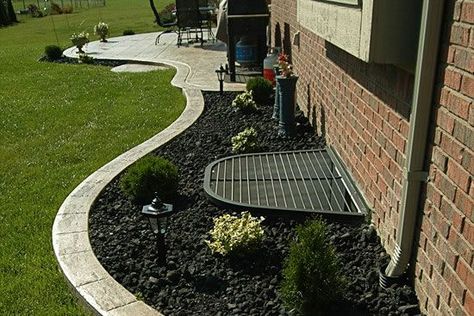 Landscaping around window well and pipes | Landscape. | Pinterest Egress Window Landscaping, Landscaping Around House, Cement Patio, Concrete Patio Designs, Exposed Aggregate, Egress Window, Window Well, Concrete Contractor, Stamped Concrete Patio