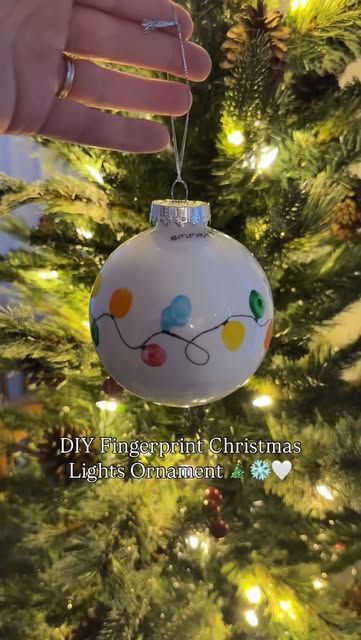 Jules | DIY baby + toddler photos • Motherhood on Instagram: "DIY Fingerprint Christmas Lights Ornament 🎄❄️🤍   Want to do this with your littles?  Make sure you’re following @diyphotoshootmom and comment DIY ORNAMENT and I’ll send you the step-by-step directions and the supplies I used to DIY your own special fingerprint Christmas lights ornament to cherish and hang on your Christmas tree    Make sure you’re following to receive the link!   Christmas crafts / Christmas gifts / diy ornament / keepsakes / diy mom / baby keepsakes / Christmas baby / toddler crafts / Christmas with kids / first Christmas / baby’s first Christmas / first time mom / pregnant / christmas ornament / special ornament / diy ornament ideas" Christmas Ornament Crafts Clear Ball, Fingerprint Christmas Ornaments Kids, Fingerprint Lights Ornament, Toddler Christmas Handprint Ornament, Baby Footprint Christmas Tree, Christmas Craft Ornaments For Toddlers, Baby Hand Christmas Ornament, Baby Fingerprint Ornament, Finger Print Christmas Tree Ornament