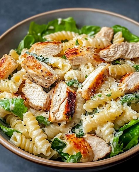 How do you enjoy this meal? Is it a solo light lunch, a delightful picnic treat, or a dish to share with friends on a sunny day? This Chicken Caesar Pasta Salad is versatile and delicious. It features tender chicken breast, your choice of pasta, crisp Romaine lettuce, juicy cherry tomatoes, and a touch of red onion. Tossed with Caesar dressing and topped with Parmesan cheese and crunchy croutons, it's a refreshing and satisfying option. Add a sprinkle of fresh parsley for a burst of flavor. Shredded Lettuce Recipes, Grilled Romaine Lettuce, Chicken Caesar Pasta, Caesar Pasta Salad, Lettuce Recipes, Caesar Pasta, Chicken Caesar Pasta Salad, Caesar Chicken, Pasta Salad Ingredients