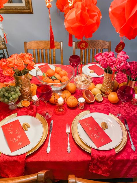 Bowls of fruit, roses in gold vases and hanging red lanterns adorn this table for this Lunar New Year celebration at home Seollal Decorations, Lunar New Year Table Decor, Lunar New Year Centerpieces, Lunar New Year Tablescape, Lunar Year Decoration, Chinese New Year Tablescape, Chinese New Year Home Decor, Lunar New Year Traditions, Lunar New Year Table Setting