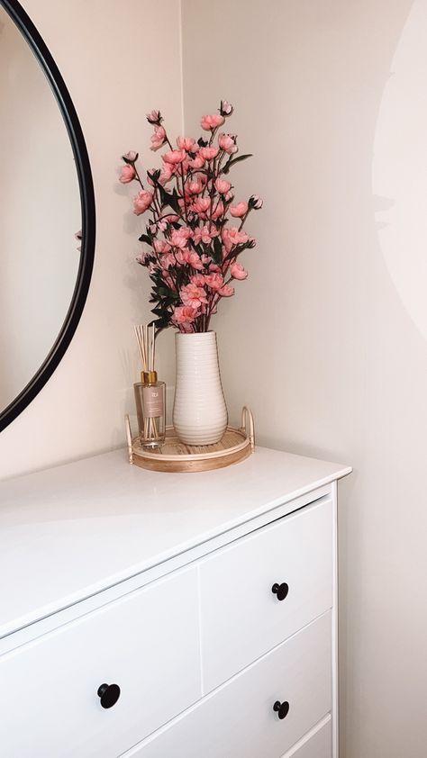 Adding a cute arrangement on top of a white dresser keeps the minimalist aesthetic yet brings a adorable pop of color to your room Clean Girl Dresser Decor, Circle Mirror Dresser, Dresser With Flowers In Drawers, Long Dresser With Circle Mirror, Faux Floral Arrangement Top Dresser, White Dresser, The Minimalist, Pop Of Color, Minimalist Aesthetic