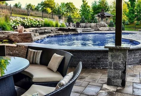 A semi above-ground pool is a hybrid between an above-ground pool and an in-ground pool. It's a pool that is only partially above ground with a small wall. Pool Off Patio, Semi Above Ground Pool, Prefab Walls, Aboveground Pool, Backyard Spa, Oval Pool, Relaxing Pool, Raised Patio, Stock Tank Pool