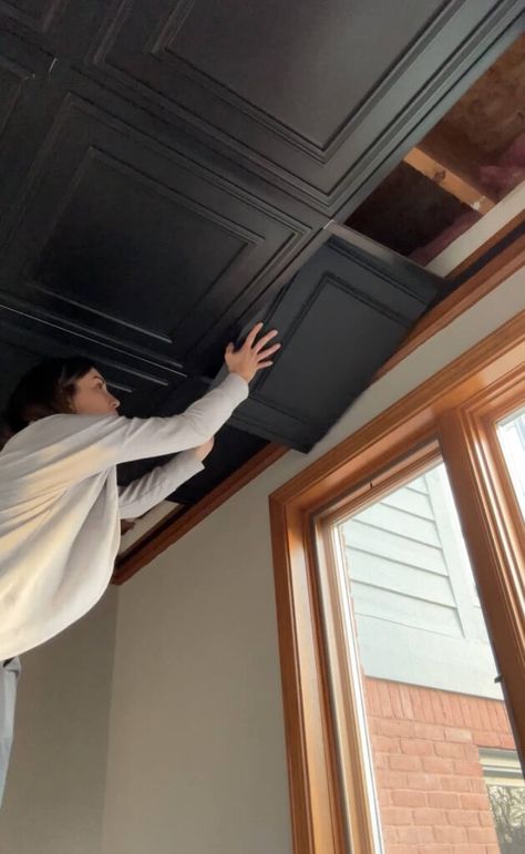 Melissa Tyler popping in a cut tile into her basement drop ceiling. How To Change Drop Ceilings, Drop Ceiling Basement Makeover, Low Drop Ceiling Basement Ideas, Dropdown Ceiling Ideas, 7ft Basement Ceiling Ideas, Basement Upgrade On A Budget, How To Redo Drop Ceiling, Drop Ceiling Replacement Ideas, Drop Ceiling Upgrade