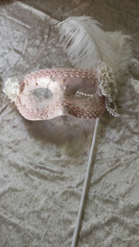 Hand made Masquerade Venetian Style Eye Mask Soft pink base with gold thread lace overlay embellished with pearls, hand made paper flowers and feathers and side pearl drop.  Decorated hand wand. Ideal for brides, masquerade balls, fashion parades or simply display as an art piece Pink Masquerade Ball, Masquerade Quinceanera Ideas, Masquerade Mask Aesthetic, Audrey Aesthetic, Lace Mask Masquerade, Masquerade Mask Ideas, Pink Masquerade Mask, Masquerade Mask Party, Pink Masquerade